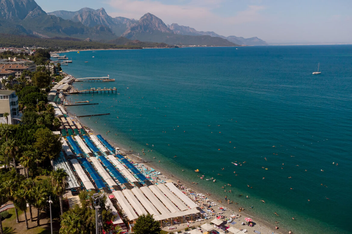 Clear turquoise waters and historic ruins at Phaselis Beach, Antalya, Turkiye.