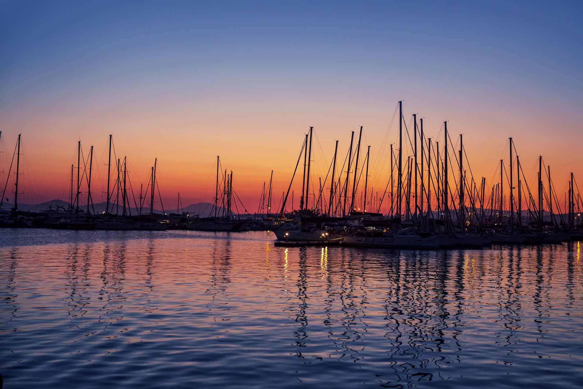 Sunset over Cesme Marina with sailing boats in Turkiye