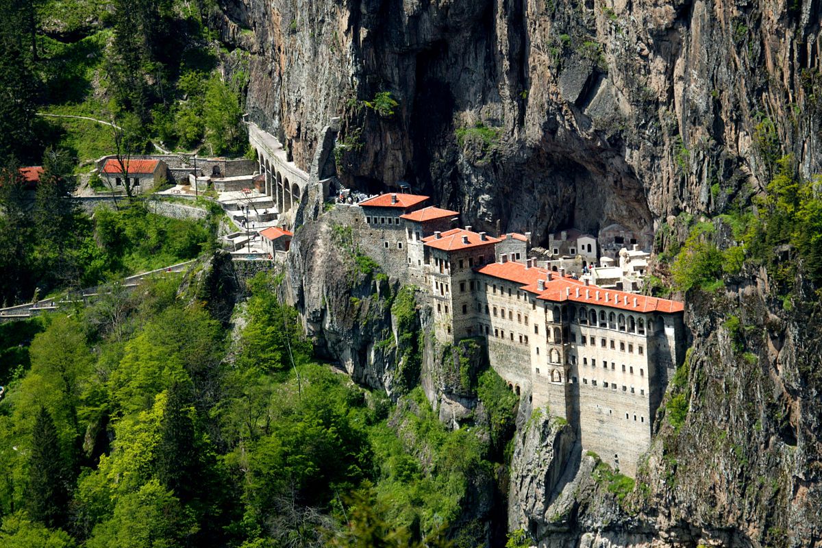 Sumela Monastery perched on a cliff with a stunning view of the Black Sea mountains.