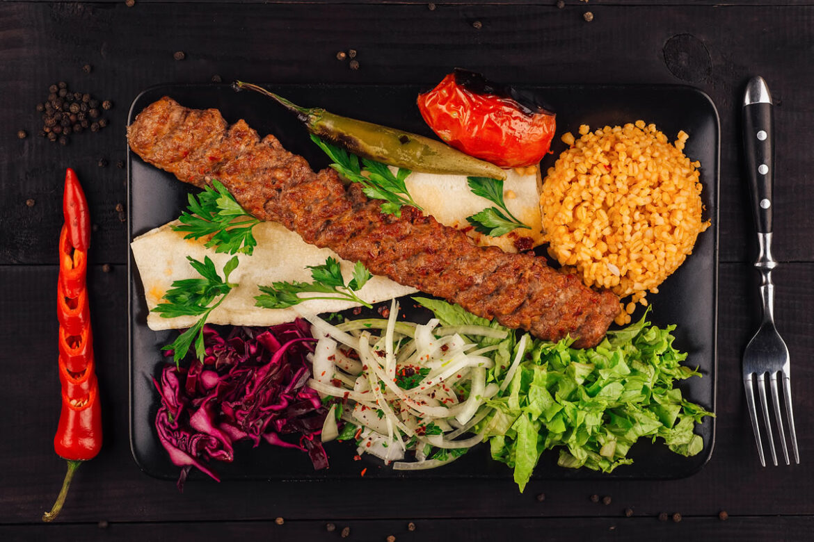 A colourful table filled with traditional Turkish kebabs and assorted mezes.
